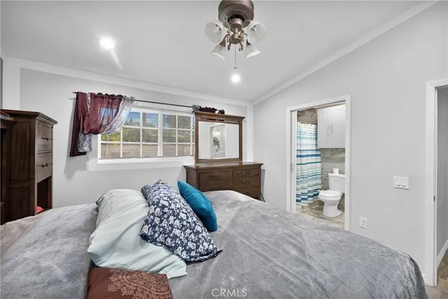 a bathroom with a granite countertop toilet sink and mirror