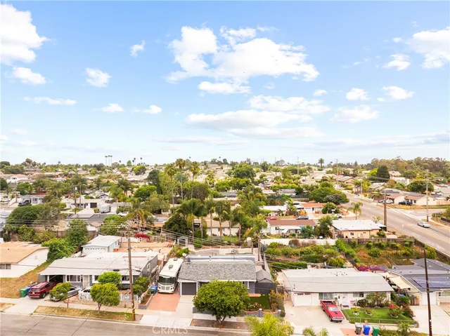an aerial view of a house with a yard and large trees
