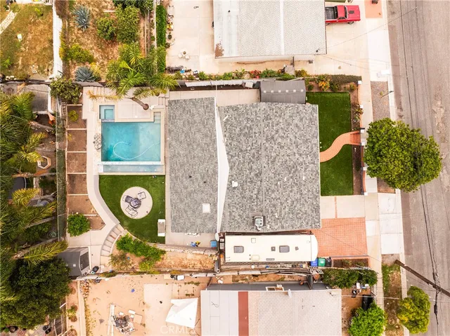 an aerial view of a house with a big yard and potted plants