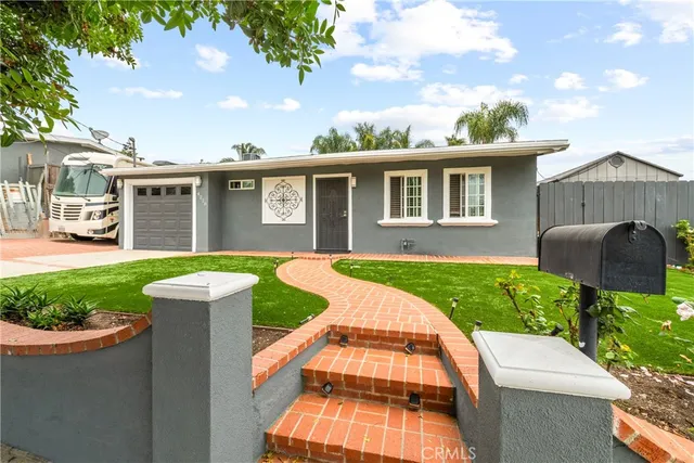 a view of a house with pool and chairs