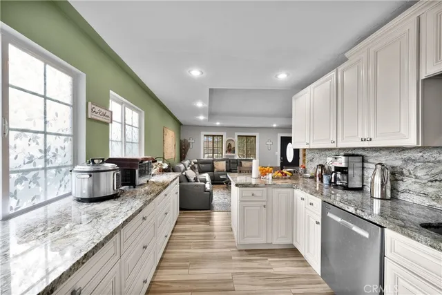 a large white kitchen with lots of counter top space