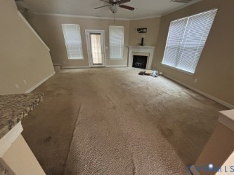 726 Albertine Court Chesapeake, VA 23320 - Photo 7 of 21 Unfurnished living room featuring a fireplace, car