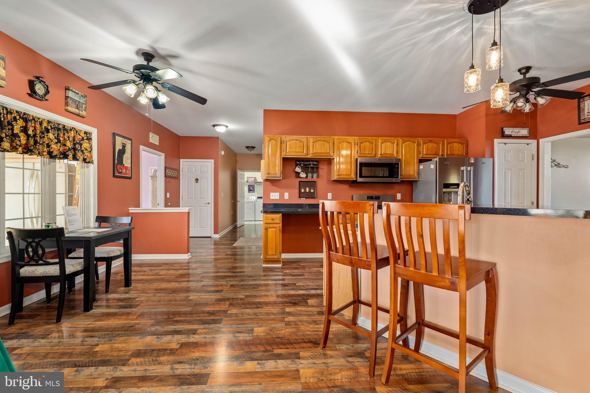 7 Club Lane Earleville, MD 21919 - Photo 19 of 48 a view of a dining room and livingroom with furniture wooden floor a chandelier