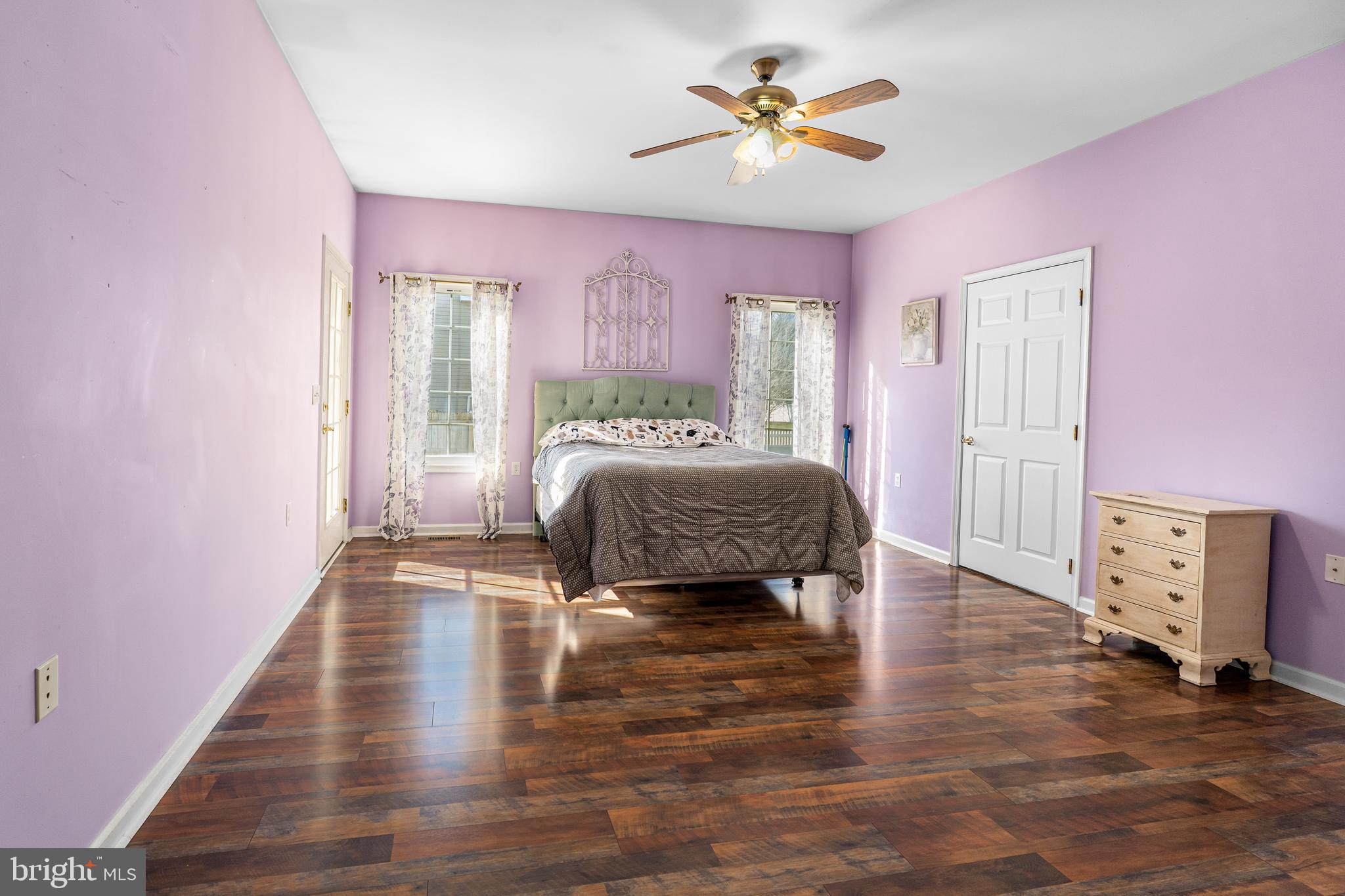 7 Club Lane Earleville, MD 21919 - Photo 26 of 48 a spacious bedroom with a bed and a chandelier