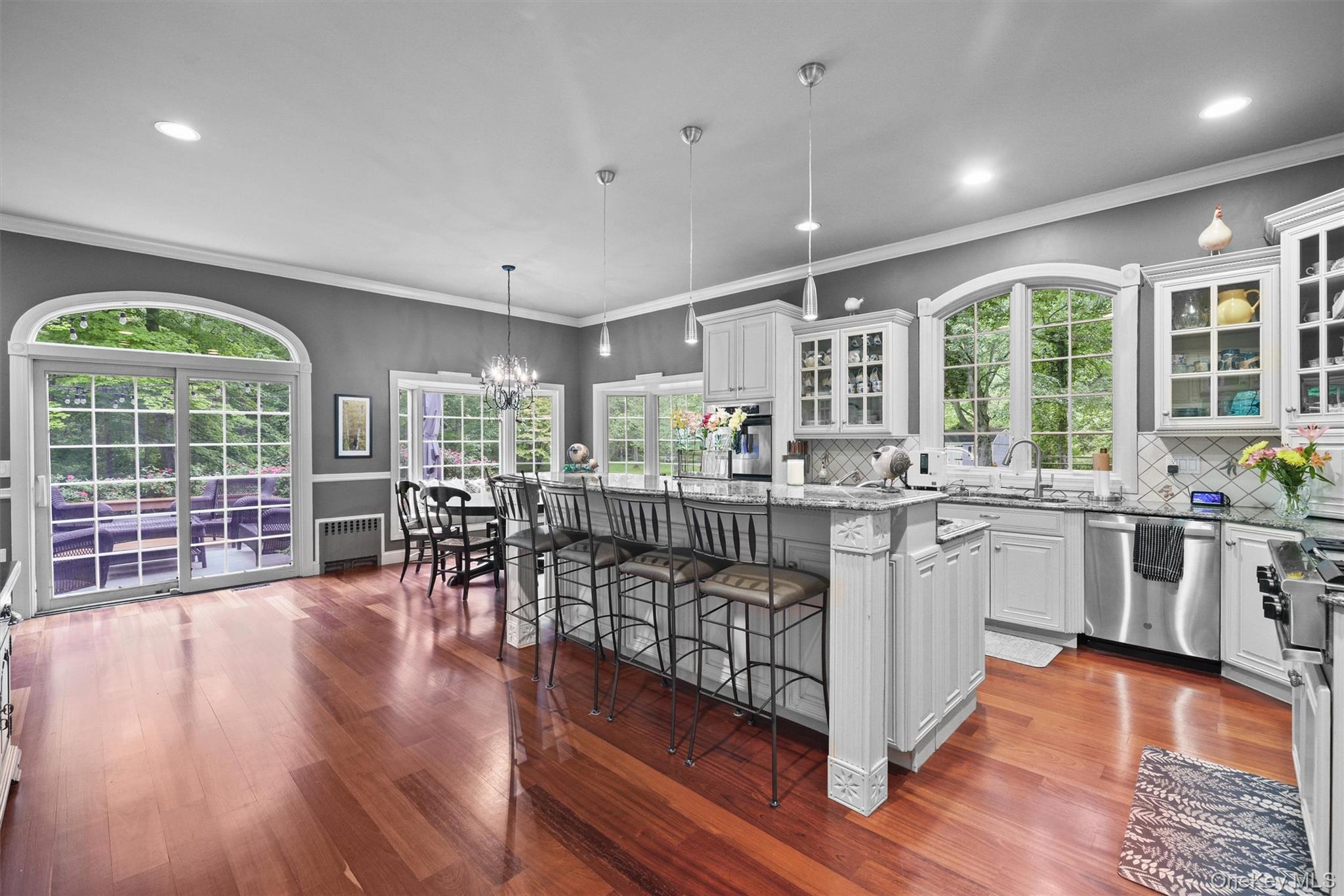 383 Illington Road Ossining, NY 10562 - Photo 13 of 50 a open kitchen with granite countertop a stove top oven a sink and a wooden floors