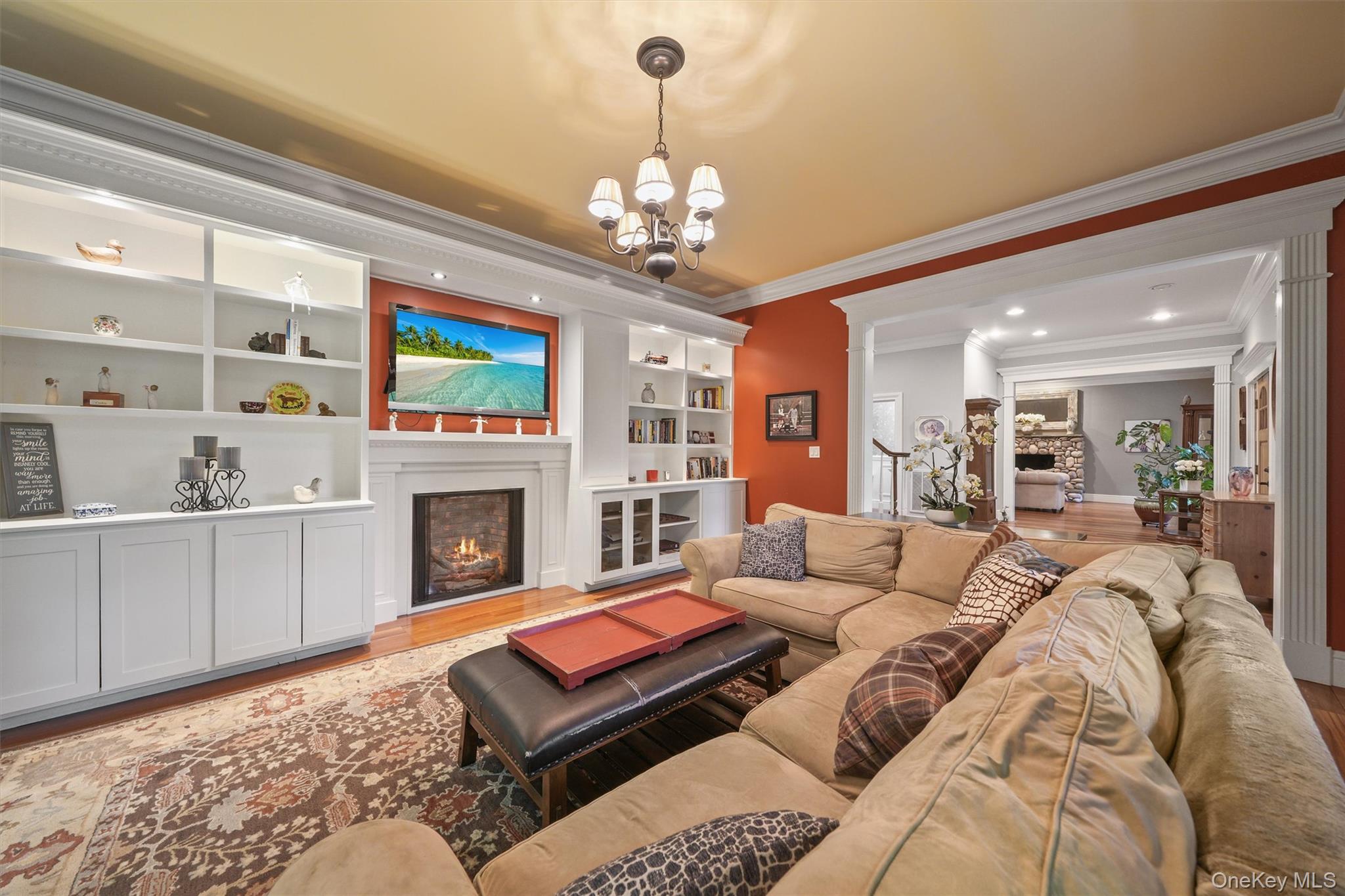 383 Illington Road Ossining, NY 10562 - Photo 17 of 50 a living room with furniture a fireplace and a chandelier