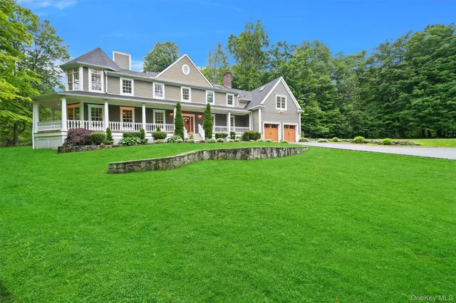 a front view of a house with a yard and trees