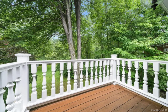 a balcony with wooden floor and fence