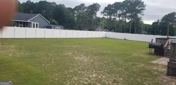 a view of a backyard with sitting area