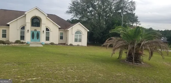 a front view of a house with a yard