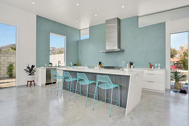 a hallway with cabinets a washer and dryer