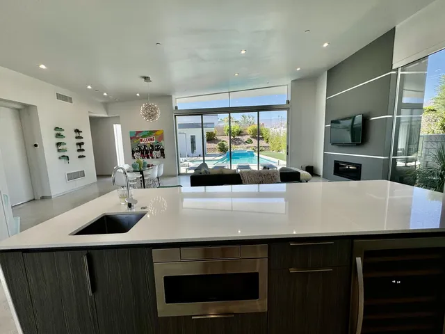 a kitchen with kitchen island a sink appliances and a counter top space