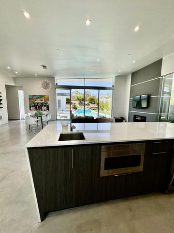 a kitchen with a sink and large cabinets
