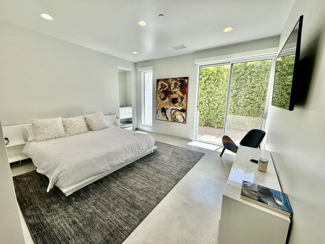 a bedroom with a large bed and a large window