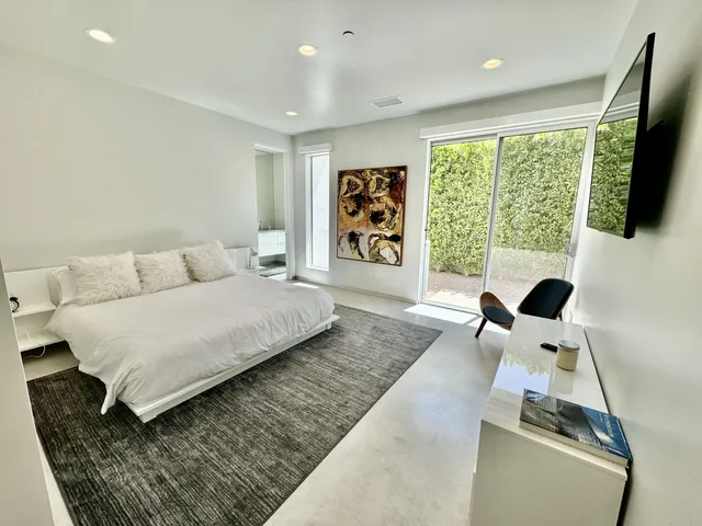 a bedroom with a large bed and a large window