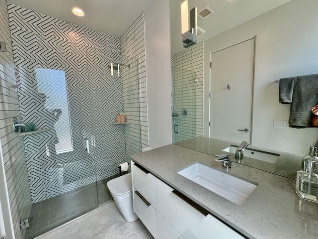 a bathroom with a double vanity sink and mirror