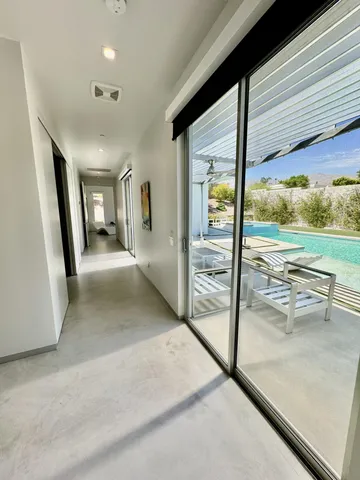 a view of a room with wooden floor and floor to ceiling window
