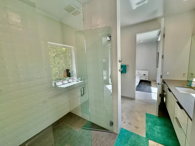 a bathroom with a double vanity sink and mirror