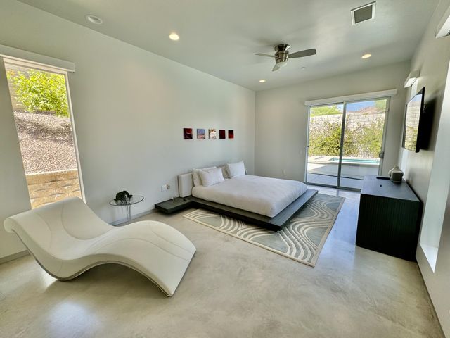 a bedroom with furniture and a flat screen tv