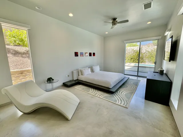 a bedroom with furniture and a flat screen tv