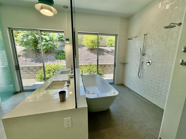a view of bathroom with a tub and sink