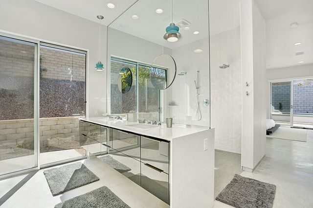 a bathroom with a tub sink shower and mirror