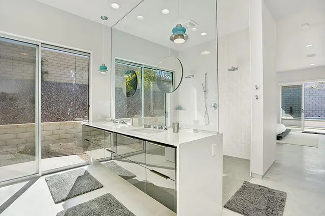 a bathroom with a tub sink shower and mirror