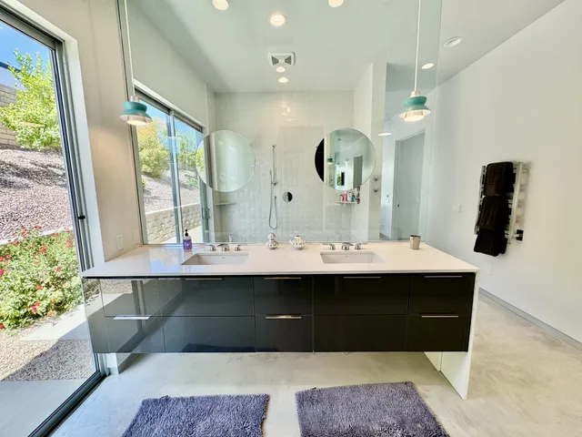 a view of bathroom with a sink and mirror