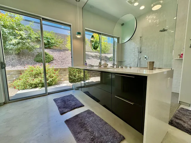 a living room with a large window and a table