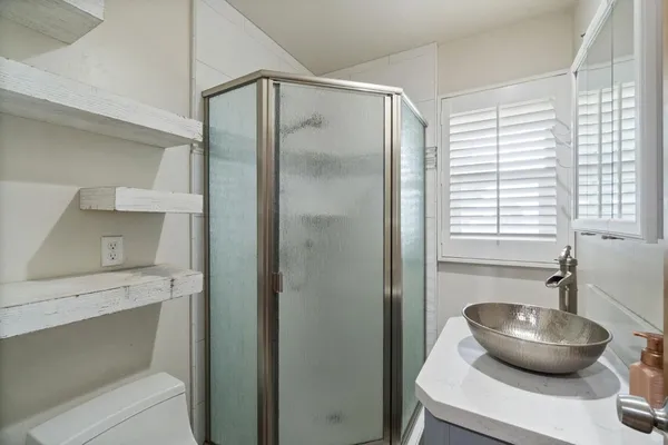 a bathroom with a sink a toilet and mirror