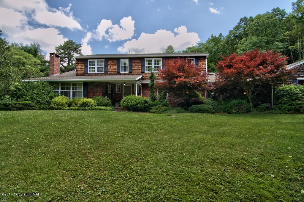 a front view of house with yard and green space