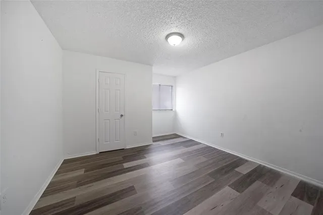 a view of wooden floor and windows in a room