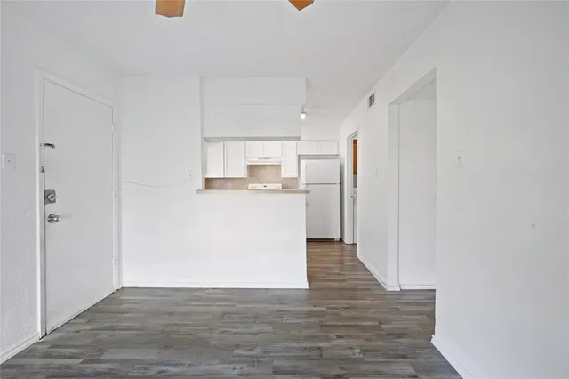 a view of a kitchen with wooden floor
