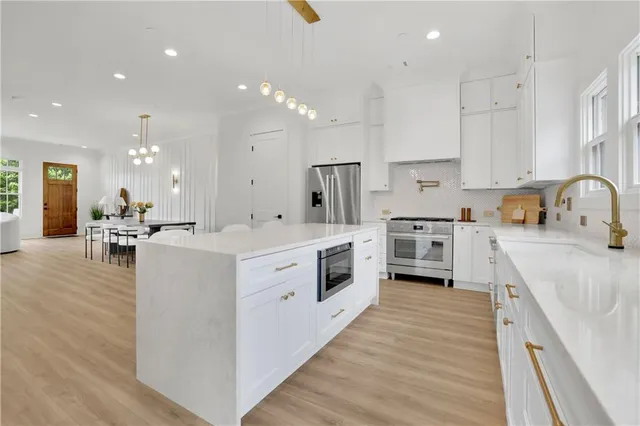 a large kitchen with stainless steel appliances lots of counter top space