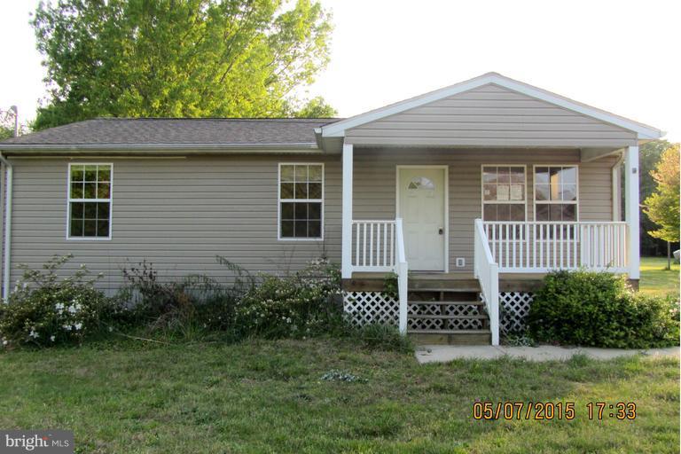 13765 Point Lookout Road Ridge, MD 20680 - Photo 1 of 15 a front view of a house with a garden