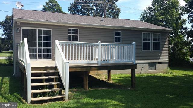 13765 Point Lookout Road Ridge, MD 20680 - Photo 2 of 15 a front view of a house with a garden