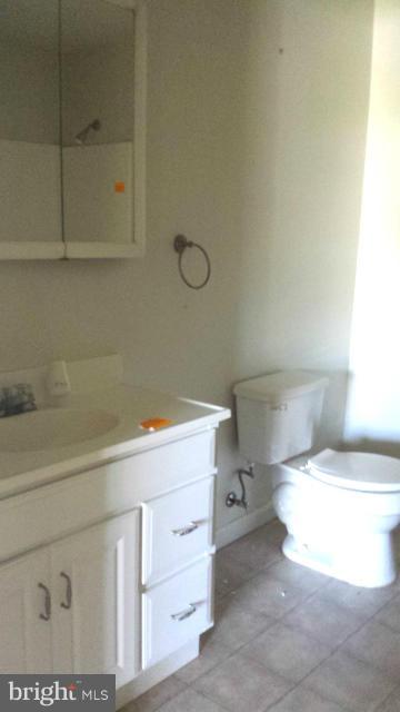 13765 Point Lookout Road Ridge, MD 20680 - Photo 11 of 15 a bathroom with a sink a toilet and vanity