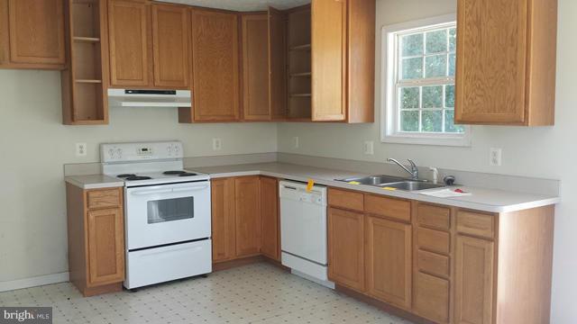 13765 Point Lookout Road Ridge, MD 20680 - Photo 6 of 15 a kitchen with a sink and a stove top oven