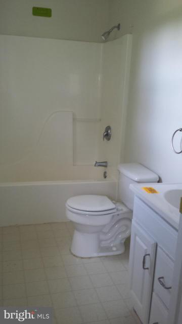 13765 Point Lookout Road Ridge, MD 20680 - Photo 10 of 15 a white toilet sitting next to a bathroom sink