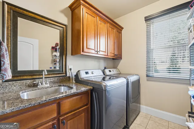 a utility room with a sink washer and dryer