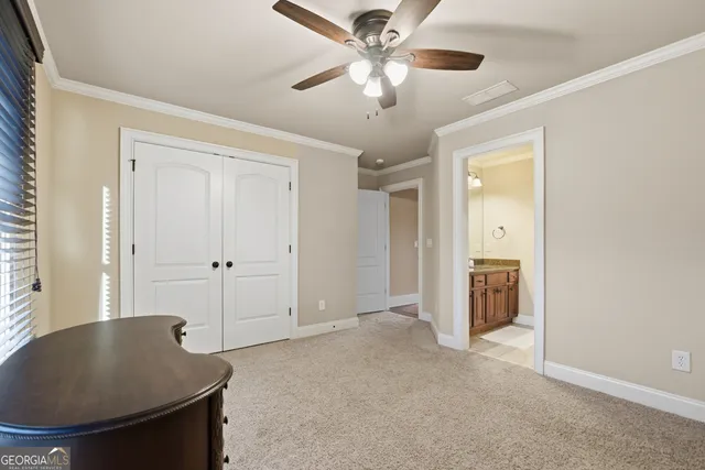 a living room with a ceiling fan and a window