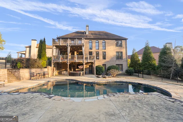 a view of pool with yard and lake view