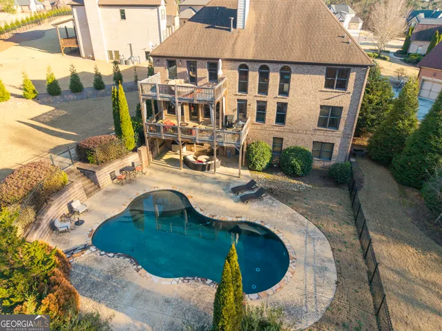 an aerial view of a house with outdoor space
