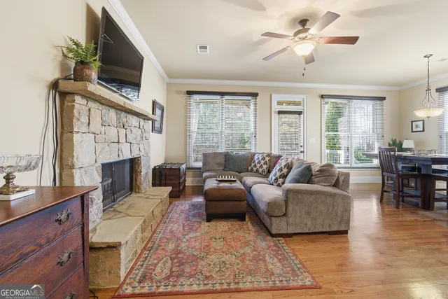 a living room with furniture a fireplace and a flat screen tv
