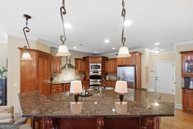 a kitchen with a table chairs refrigerator and microwave