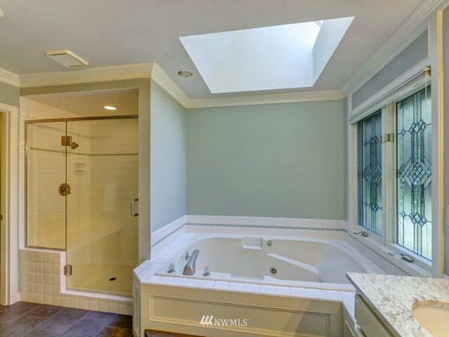 a bathroom with a tub and shower