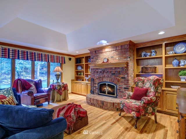 a living room with furniture a rug and a fireplace