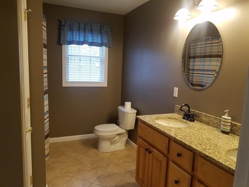 18 Channing Road East Longmeadow, MA 01108 - Photo 30 of 40 a bathroom with a granite countertop sink a mirror and a toilet