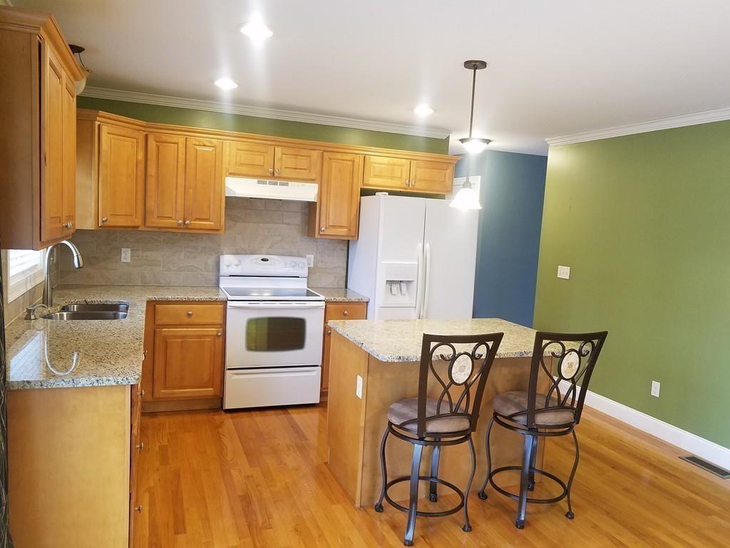 18 Channing Road East Longmeadow, MA 01108 - Photo 9 of 40 a kitchen with a table chairs refrigerator and cabinets