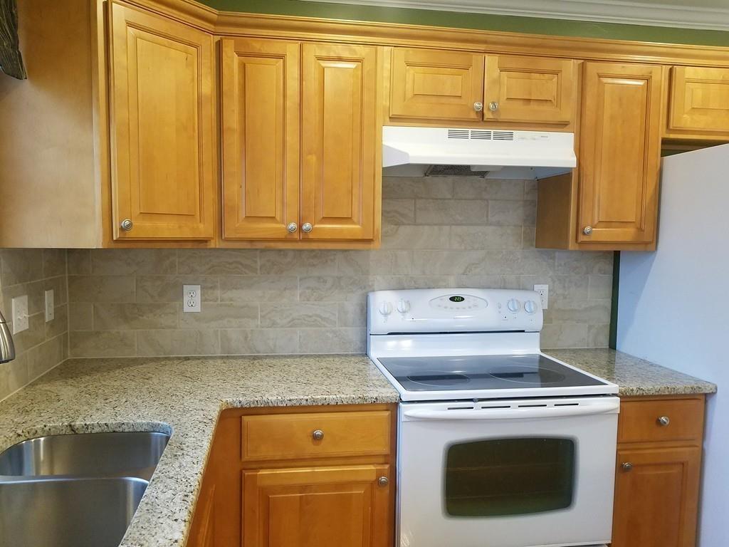 18 Channing Road East Longmeadow, MA 01108 - Photo 10 of 40 a kitchen with granite countertop wood cabinets and a stove top oven